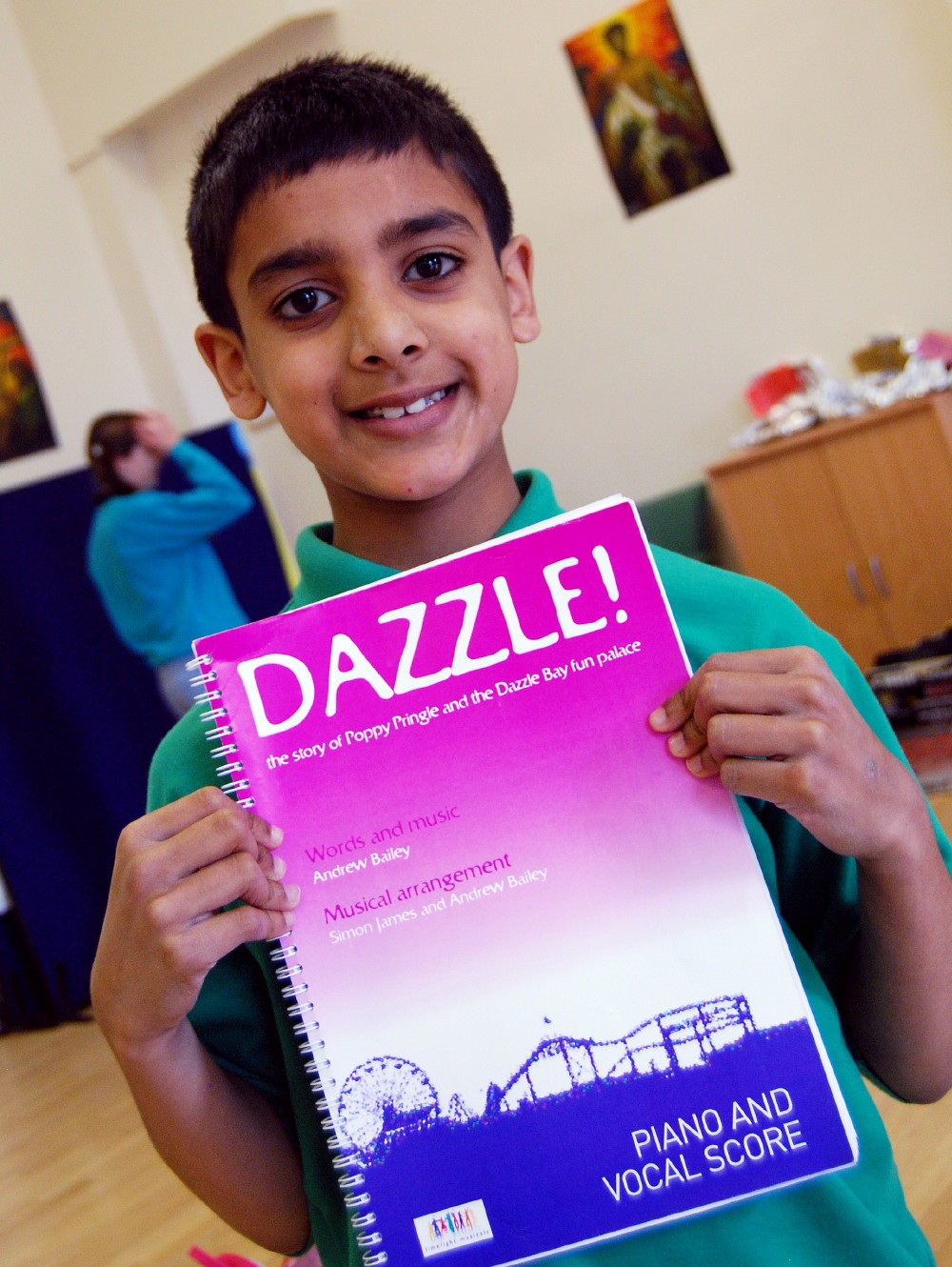 A young member of the Carmel Thomas Youth Singers and the score from Dazzle, the children's musical